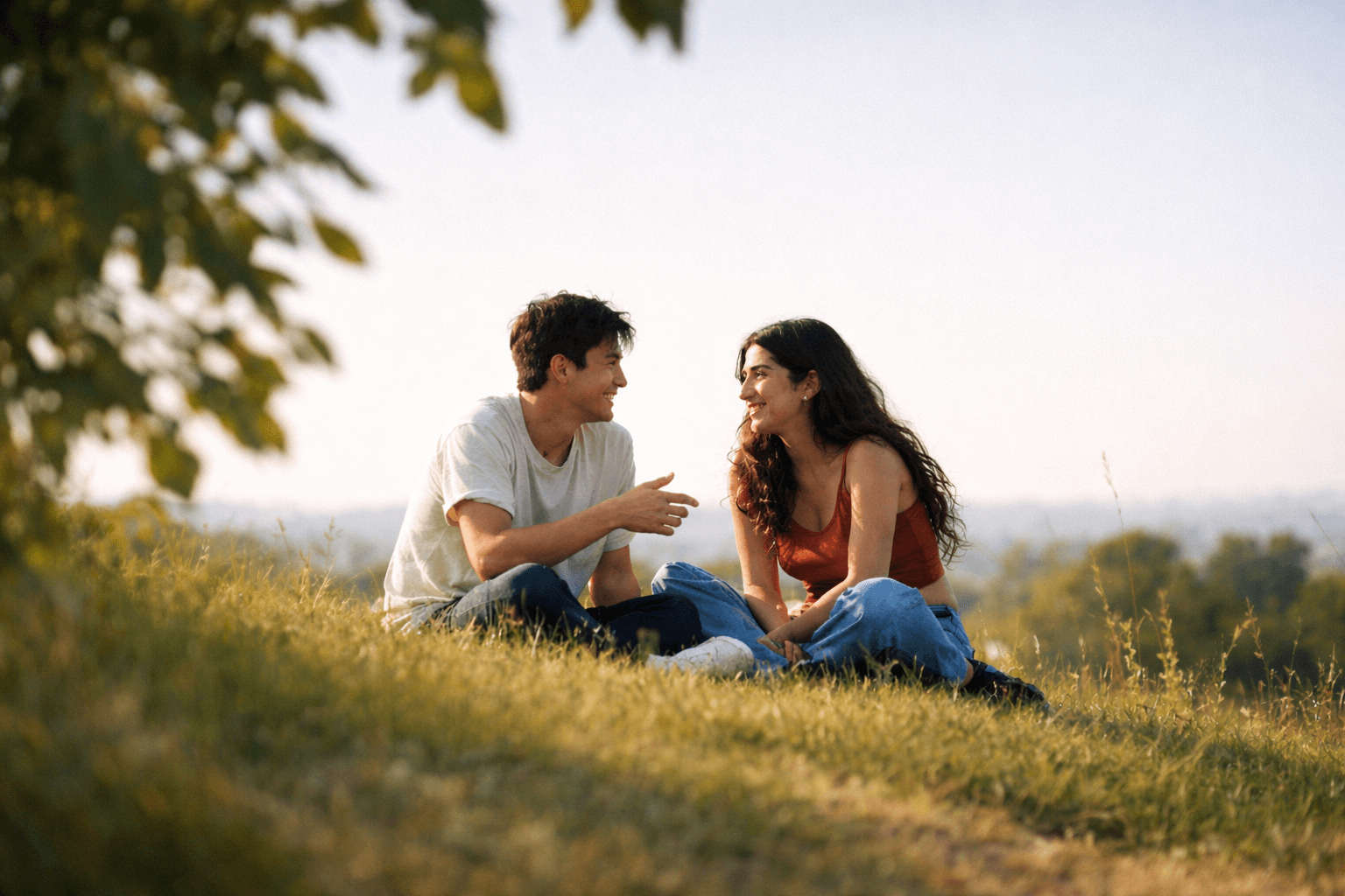 Couple sitting in a field having a conversation